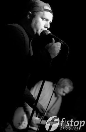 Charlie singing, Dave on guitar behind him.